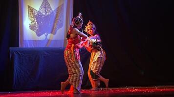 Traditional dancer performing with bow and arrow on stage video