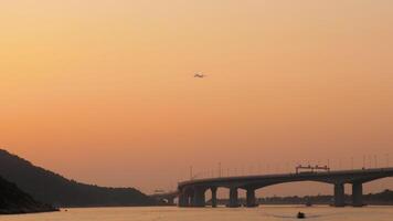 aereo mosche alto al di sopra di il città ponte a tramonto. famoso macau ponte nel hong kong a tramonto video