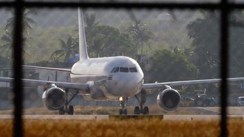 Jet passenger plane taxiing on the airfield. Airliner in backlight. Airport, air traffic video