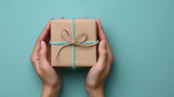 Womans Hands Holding Gift Box With Pink Bow photo