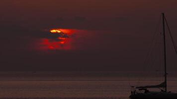 Picturesque sunset on the ocean. Yacht silhouette floating off the shore. Footage timelapse. Nature environment background video