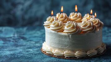 Cake With White Frosting and Lit Candles photo