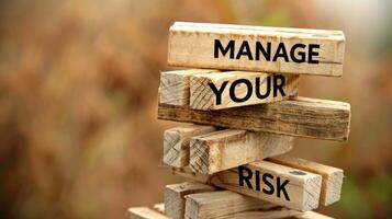 Manage Your Risk. Risk Management. Wooden blocks stacked to form a message about managing risk photo