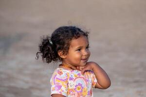 Contemplative black child with a backdrop of soft focus, embodying themes of diversity and the richness of African American heritage, sparking joy and curiosity, happiness. photo