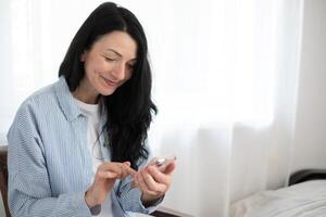 Radiant midlife lady engaged with tech, phone, her smile reflecting the light-hearted side of the digital era, and funny moments with technology. photo