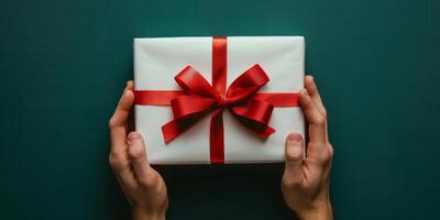 Person Holding White Gift Box With Red Ribbon photo