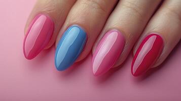 Womans Hand With Pink and Blue Nail Polish photo