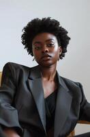 Woman in Suit Sitting in Chair photo