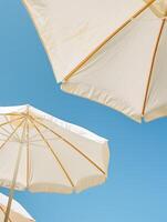Two White Umbrellas on Sandy Beach photo
