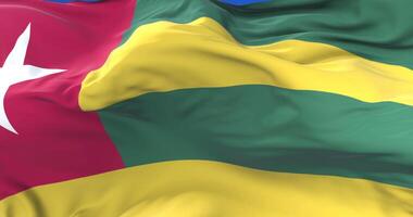 Flag of Togo waving at wind in slow with blue sky, loop video