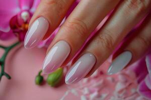 Womans Hand With White Manicure and Pink Flowers photo