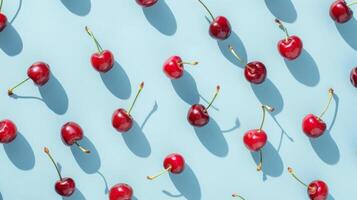 Group of Cherries on Blue Surface photo