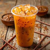 Thai tea with ice in a plastic cup photo