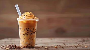Thai tea in a plastic cup with ice and a straw photo