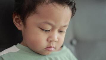 Child playing games by smartphone on sofa video