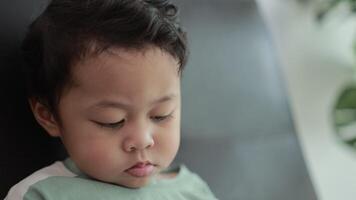 Child playing games by smartphone on sofa video