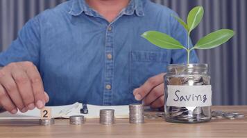 A man counting coins in a piggy bank money saving concept video