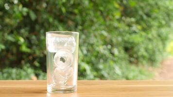Colorful soft drinks poured into glasses and placed on the table. There is a natural background. video