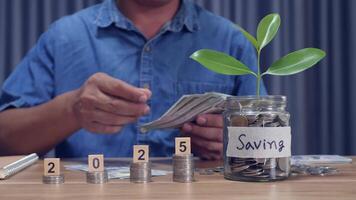 A man counting coins in a piggy bank money saving concept video