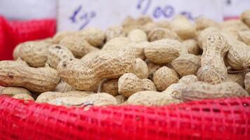 top view of Several peanuts in a basket. video