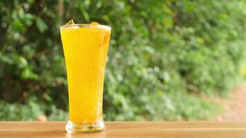 Colorful soft drinks poured into glasses and placed on the table. There is a natural background. video