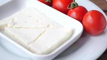 Prepare a delicious salad with fresh cheese and ripe tomatoes using this easy recipe video