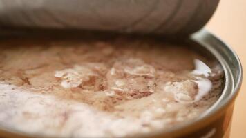 canned tuna on wooden table , video