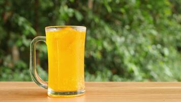 Colorful soft drinks poured into glasses and placed on the table. There is a natural background. video