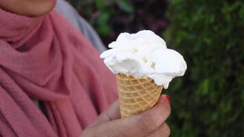 Female holds in her hand a cone with ice cream video