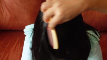 Mother makes her daughter's hair and braids. video