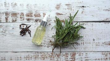 eucalyptus essential oils in a glass bottle with green leaf on white background video