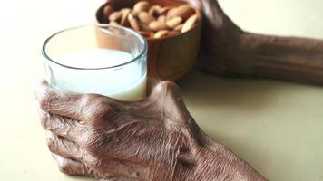 senior women hand holding a glass of milk video