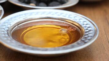 close up of fresh honey and olive in a bowl video