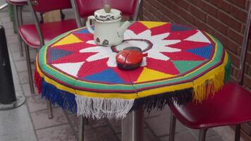 Outdoor cafe table with tea and decorations creates cozy dining experience in vibrant patio video