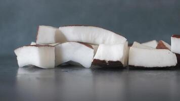 slow motion of falling slice of fresh coconut on a table video