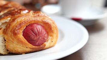 A delicious pastry with sausage presented on a white plate makes for a tempting breakfast treat video