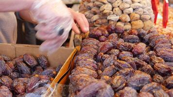 Vendors sort dates at stall, offer organic, natural, tropical fruits to shoppers video