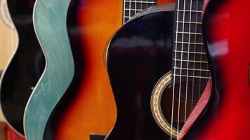 Row of colorful guitars hanging video