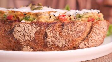 Rustic Avocado Toast with Fresh Veggies and Seed Garnish served on a White Plate video
