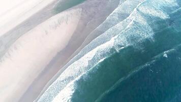 Aerial drone descending of sandy beach and ocean with waves video