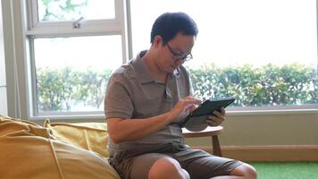 Asian man playing violin in room video