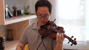 asiatico uomo giocando violino nel camera video
