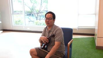 Asian man playing violin in room video