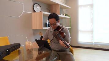 asiático hombre jugando violín en habitación video