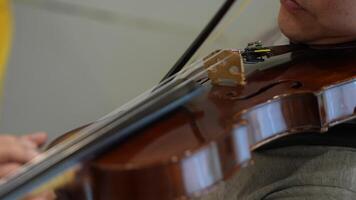 Asian man playing violin in room video