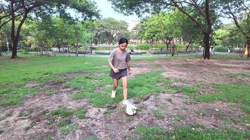 female soccer players practice using the ball in the park field diligently and happily. video