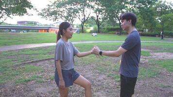 Male and female soccer players practice using the ball in the park field diligently and happily. video