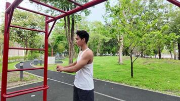 ásia homem praticando ginástica fazendo ginástica Barra e aro exercícios e alongamento e em repouso para Esportes. video