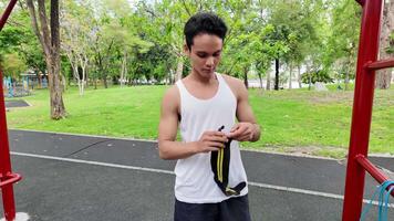 Asian man practicing gymnastics doing gymnastics bar and hoop exercises and stretching and resting for sports. video