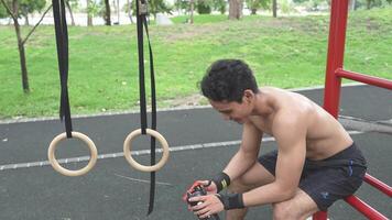 Asian man practicing gymnastics doing gymnastics bar and hoop exercises and stretching and resting for sports. video